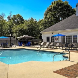 Resort-style swimming pool with lounge seating