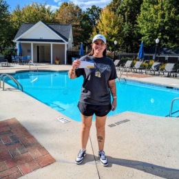 The essence of exceptional living woman standing by a pool