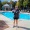 woman standing by a pool